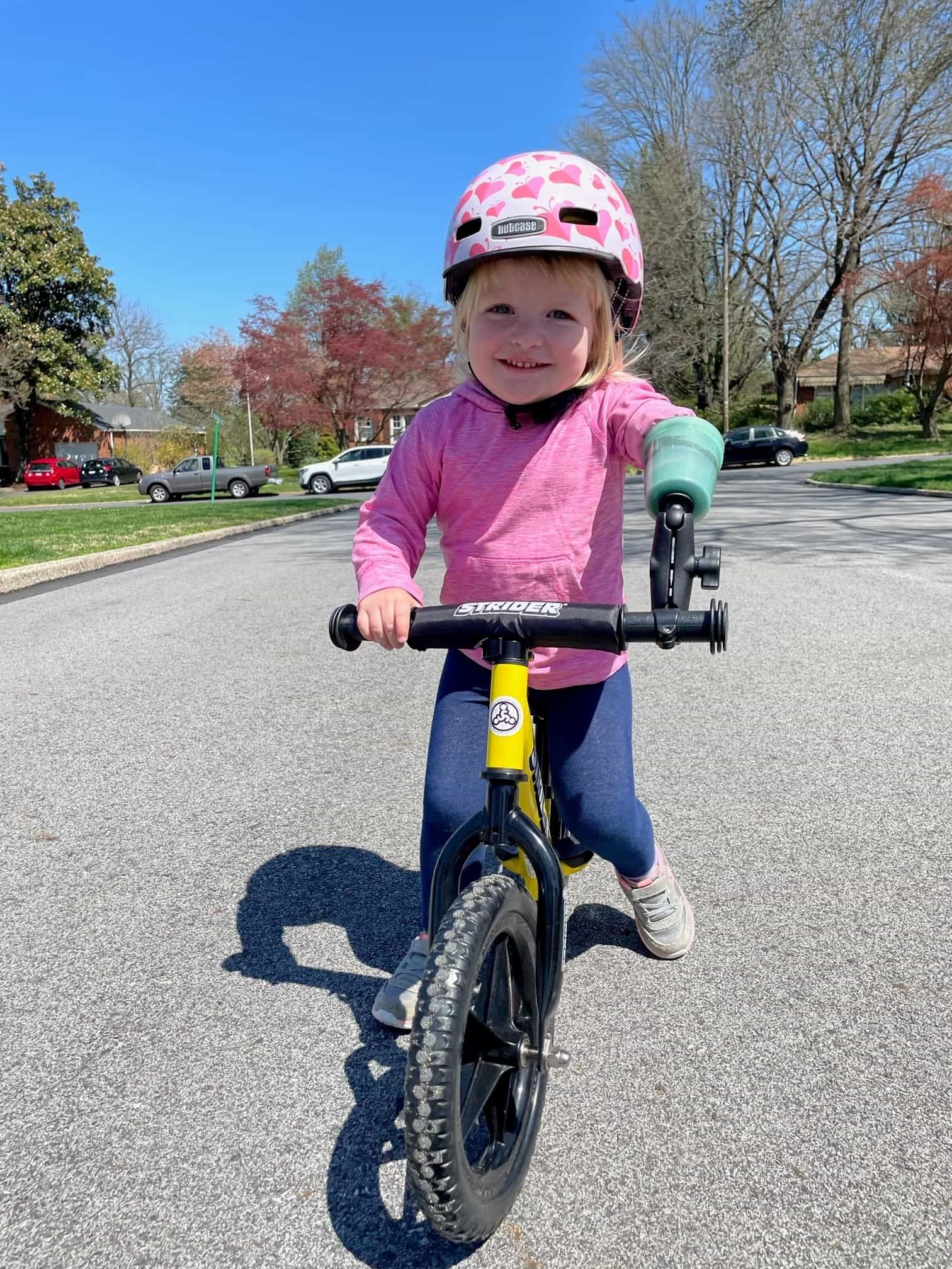 Hazel Greenfield rides her adaptive 12" Strider Sport