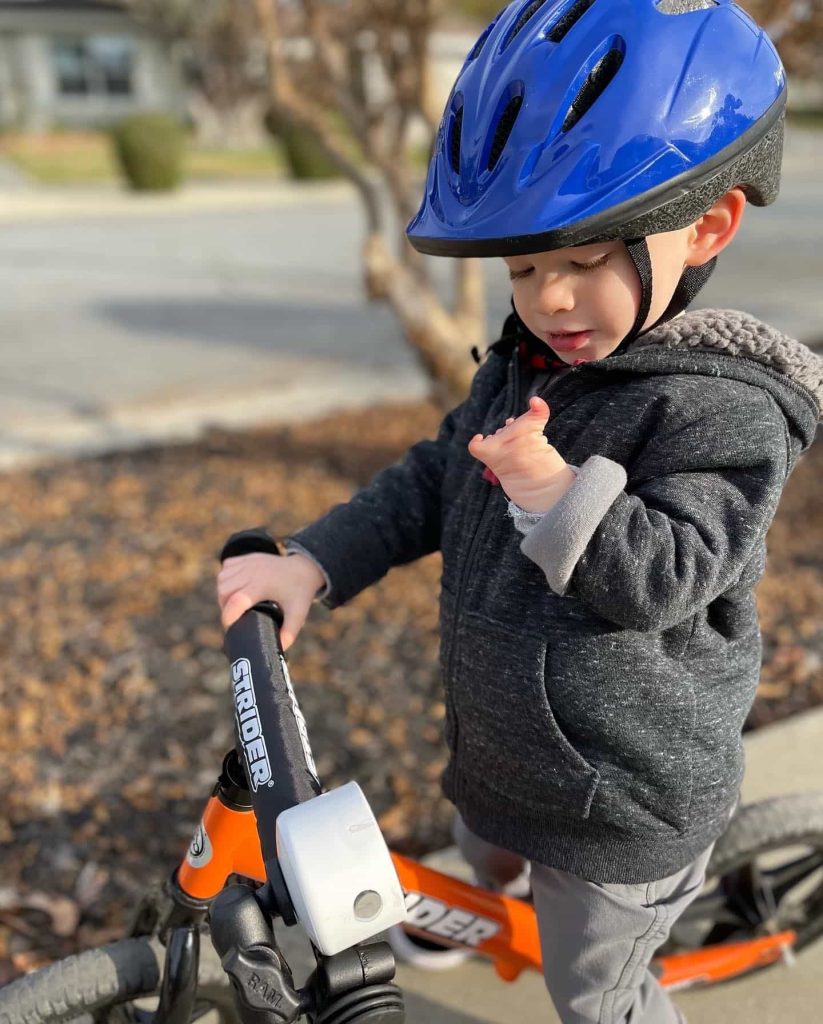 Ryder Morgan stands on his adaptive Strider 12 Sport